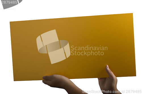 Image of Plywood yellow sign held up by hands