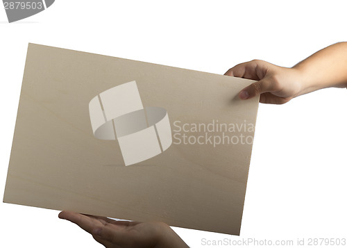 Image of Plywood sign held up by young hands