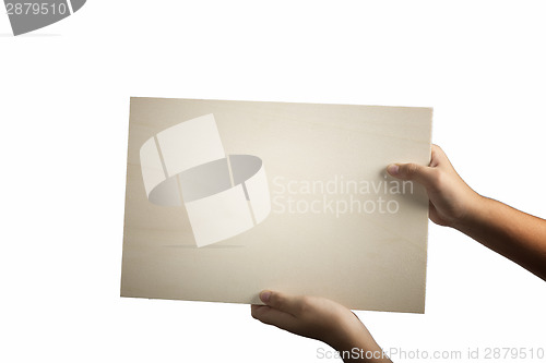 Image of Plywood sign held up by young hands