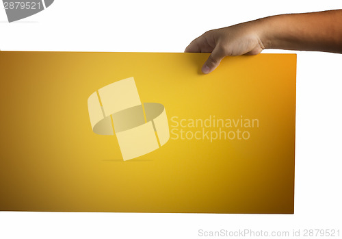 Image of Plywood yellow sign held up by hands