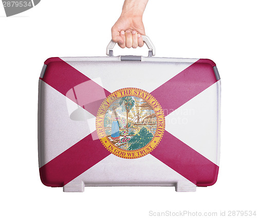 Image of Used plastic suitcase with stains and scratches