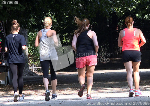 Image of Four women running outdoors
