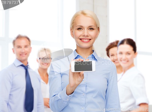 Image of smiling businesswoman with smartphone blank screen