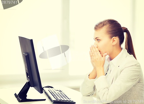 Image of stressed student with computer in office