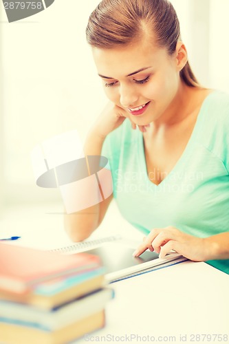 Image of attractive student girl using tablet pc