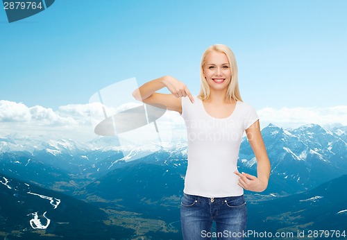 Image of smiling young woman in blank white t-shirt
