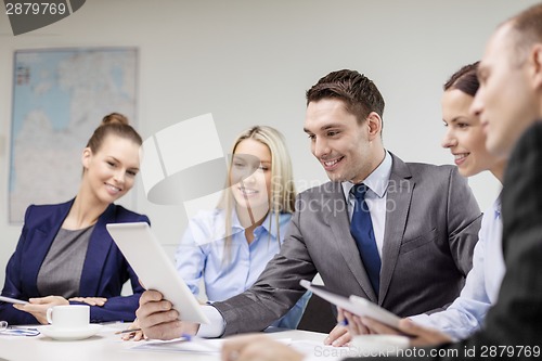 Image of business team with tablet pc having discussion