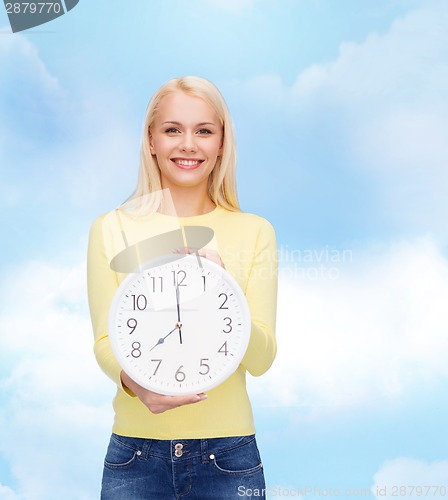 Image of student with wall clock