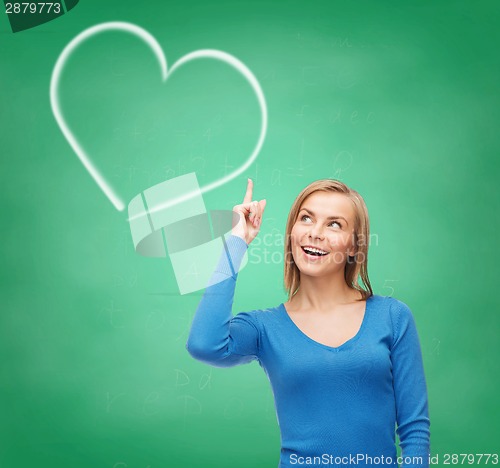 Image of smiling woman pointing her finger up