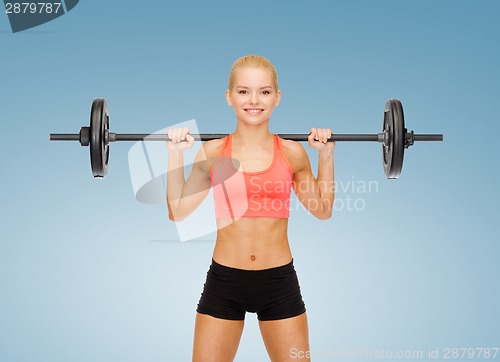 Image of smiling sporty woman exercising with barbell