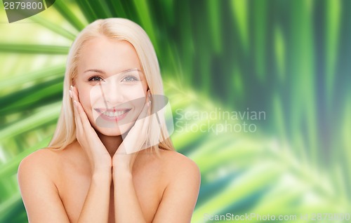 Image of beautiful woman touching her face skin