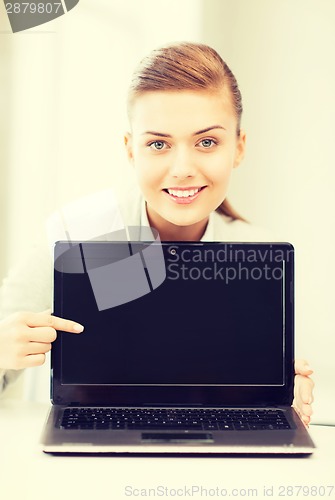 Image of businesswoman with laptop in office