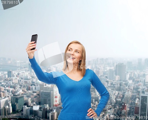 Image of woman taking self picture with smartphone camera