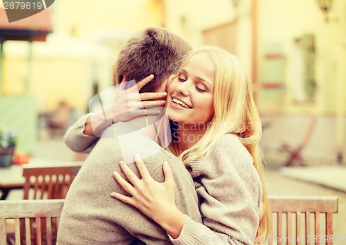 Image of romantic happy couple hugging in the cafe