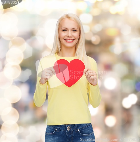 Image of smiling woman with red heart