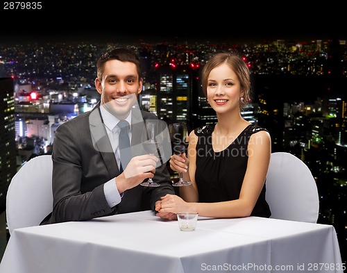 Image of young couple with glasses of wine at restaurant