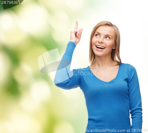 Image of smiling woman pointing her finger up