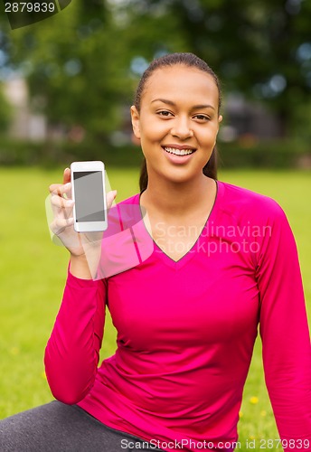 Image of smiling african american woman with smartphone