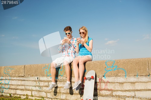Image of smiling couple having fun outdoors