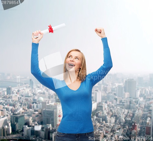 Image of smiling woman with diploma