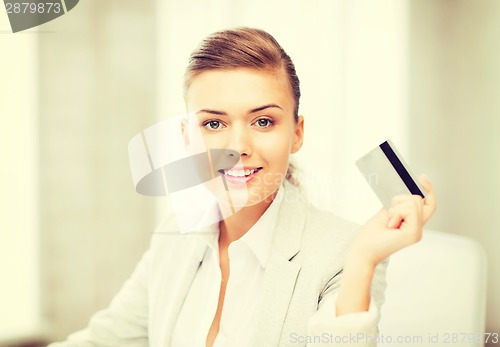 Image of smiling businesswoman showing credit card