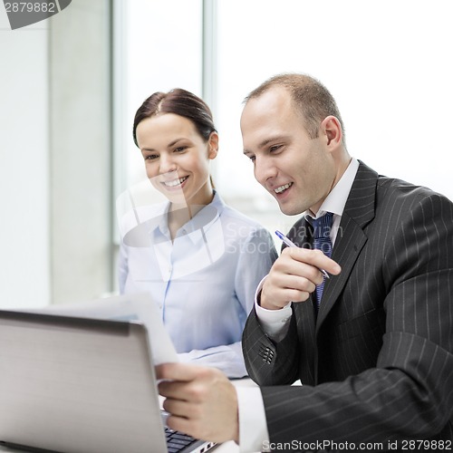 Image of businessman and businesswoman having discussion