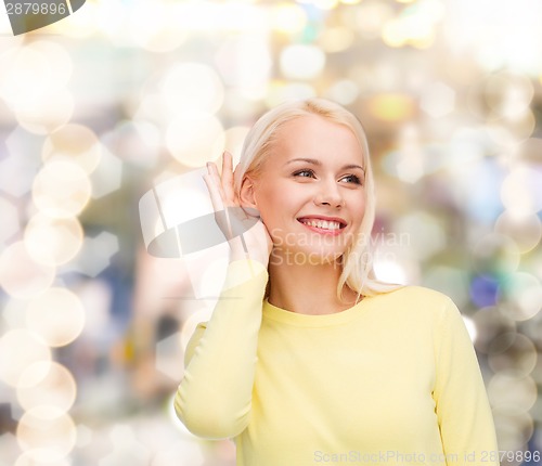 Image of smiling young woman listening to gossip