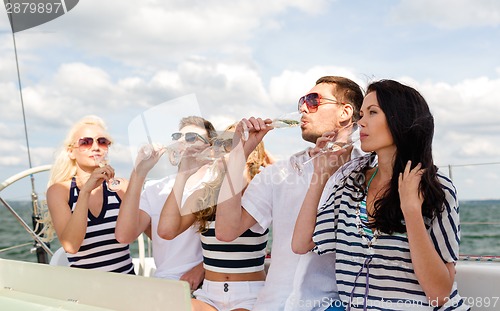 Image of smiling friends with glasses of champagne on yacht