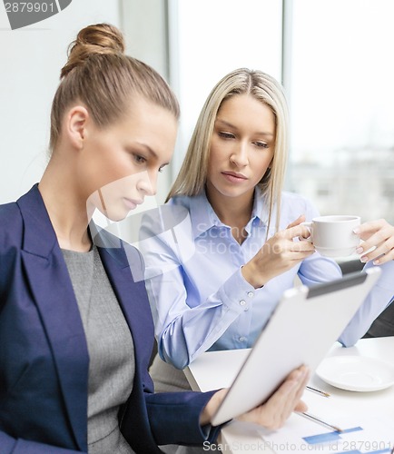 Image of business team with tablet pc having discussion