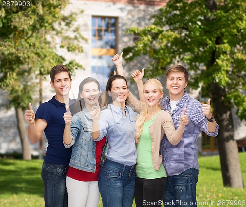 Image of group of smiling students showing thumbs up