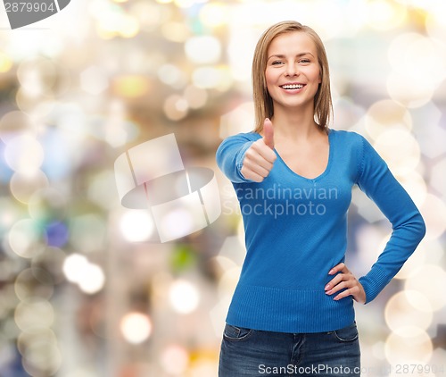 Image of smiling girl in casual clothes showing thumbs up