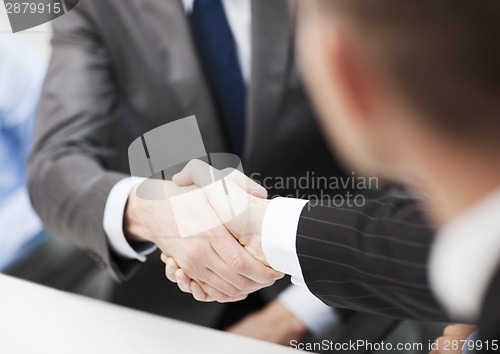 Image of two businessmen shaking hands in office