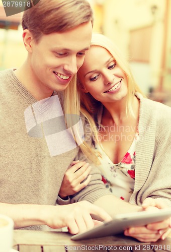 Image of smiling couple with tablet pc computer in cafe