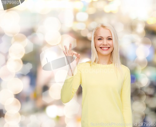 Image of young businesswoman showing ok sign