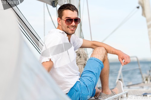 Image of man sitting on yacht deck