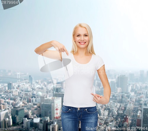 Image of smiling young woman in blank white t-shirt