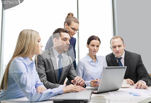Image of business team with laptop having discussion