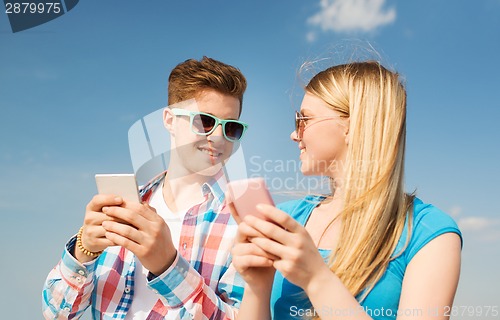 Image of smiling couple having fun outdoors