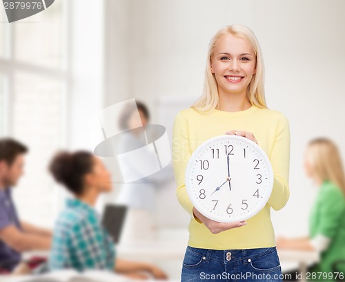 Image of student with wall clock