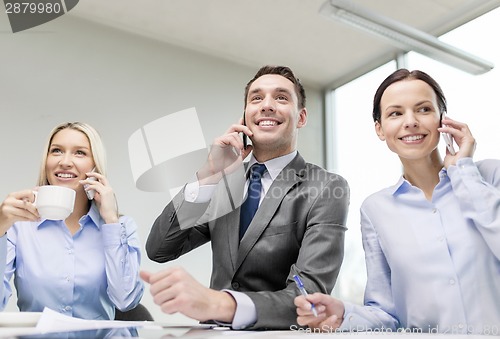 Image of business team with smartphones having conversation