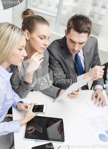 Image of business team with tablet pc having discussion
