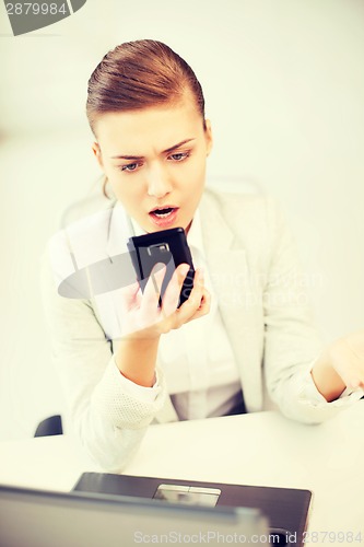 Image of woman shouting into smartphone