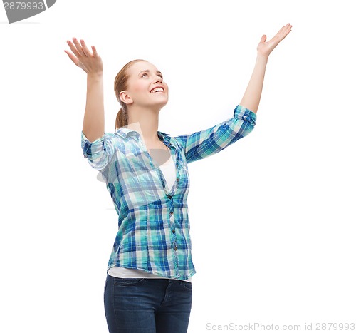 Image of smiling young woman looking up