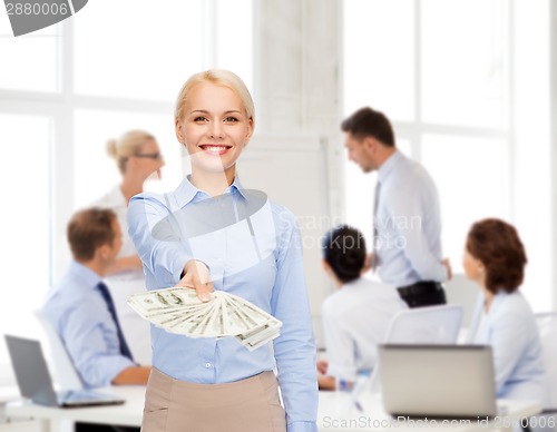 Image of young businesswoman with dollar cash money