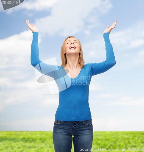 Image of laughing young woman waving hands