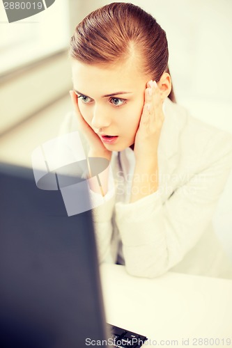 Image of stressed businesswoman with computer