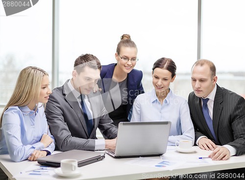 Image of business team with laptop having discussion