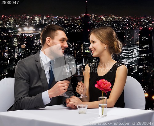 Image of young couple with glasses of wine at restaurant