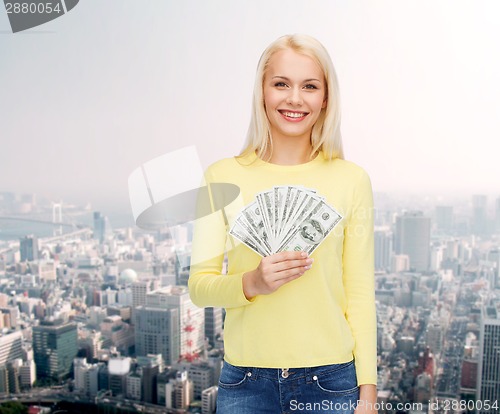 Image of smiling girl with dollar cash money