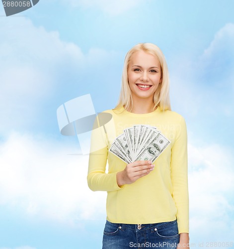 Image of smiling girl with dollar cash money